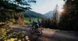 Two cyclists explore the adventurous bike trails around Alpina Alpendorf at sunset.