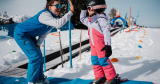 Children participating in a children's ski course at Hotel Alpina in St. Johann
