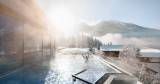 A man enjoying the wintry view at the Wellnesshotel Alpina