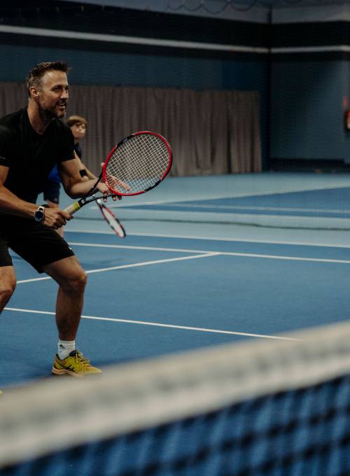 Im Tennisurlaub mit Ihren Kindern spielt eine Familie Tennis in unserer hauseigenen Tennishalle. 